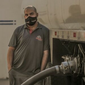 man unloading fuel from a tanker truck