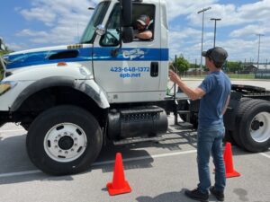 picture of man giving instructions to a driver in a truck as they conduct cdl training Chattanooga TN