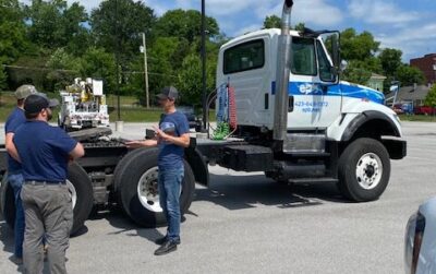 Mobile CDL Instructor speaking to students in front of a truck