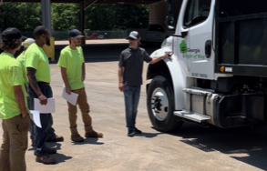 Mobile CDL instructor and students looking over a truck